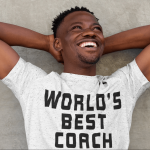 Man in "World's Best Coach" shirt